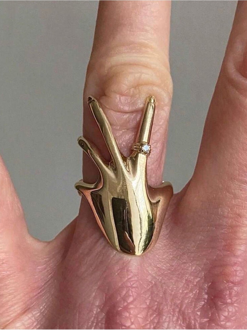 Gold Hand Sculptural Ring with Clear Accent